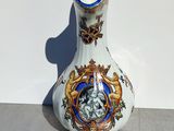 a white vase with a blue and gold design on it