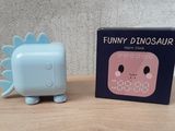 a small toy that is sitting next to a box on a table