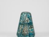 an image of a small blue glass object on a white surface
