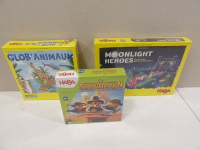 three children ' s board games are sitting on a table