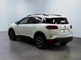 the rear end of a white suv parked in a white room