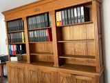 a large wooden bookcase in the middle of a living room