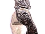 an image of a close up of a silver bracelet on a white surface