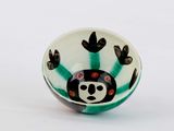 a small bowl with a monkey on it on a white surface