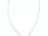 a gold necklace with a black stone pendant on a gold chain