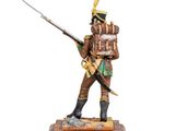 statue of a soldier with a sword and a hat on a wooden base