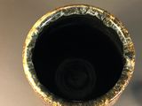 a close up of a vase on a table