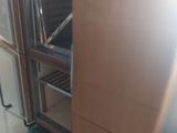 a refrigerator that is sitting on a pallet in a room