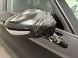a car that has a black cover on it ' s side mirror