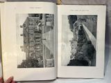 someone is holding a book open to a picture of a city
