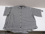 a black and white checkered shirt sitting on top of a table