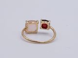 a close up of a gold ring with two pink stones