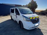 a white van parked in front of a building with the sun shining on it