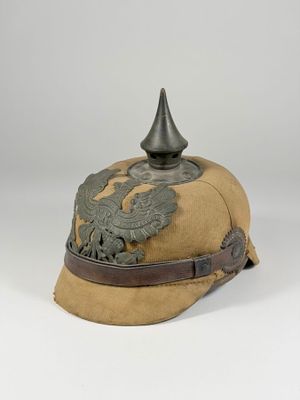 un gros plan d'un chapeau orné d'une décoration métallique