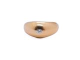 a close up of a gold ring with a diamond on it