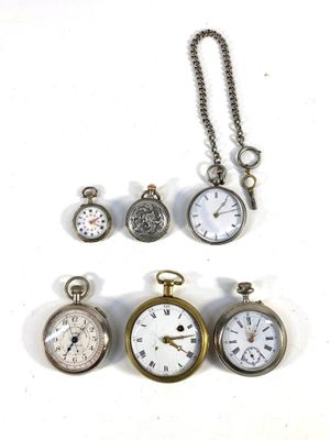 many different types of pocket watches displayed on a white surface