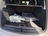 the back of a car with a bed in the trunk of it