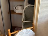 a baby chair in the corner of a small room