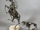 statue of a man on a horse and a dog on a marble base