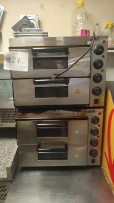 three ovens stacked on top of each other in a kitchen