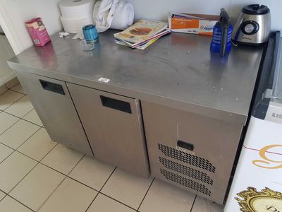 un comptoir en acier inoxydable sur lequel sont posés tout un tas d'objets