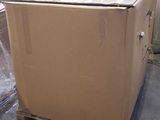 a cardboard box sitting on a pallet in a warehouse