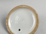 a close up of a white and brown cup on a table