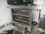 a small oven with a lot of cooking utensils in it
