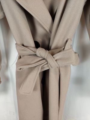 the coat is tan and has a large bow on the front