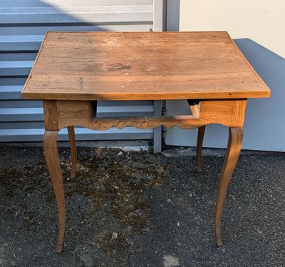 a small wooden table with a drawer underneath it