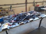 a lot of tools on a table in a garage