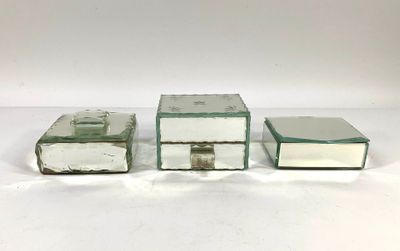 three pieces of glass sitting on top of a white surface
