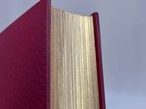 a red book that is open on a table