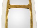 un miroir blanc et doré avec un cadre doré