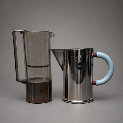 two pitchers and a pitcher of water on a table