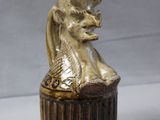 a small vase with a cat in it on a table