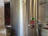 a large stainless steel water heater in a room