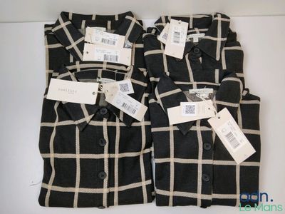 two men ' s black and white plaid shirts with price tags on them