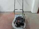 a picture of a lawn mower parked in a garage