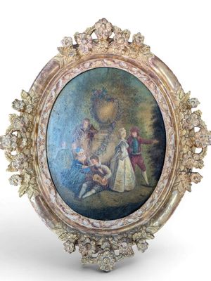 an oval picture frame with a painting of a man and a woman