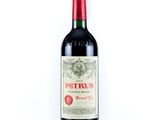 une bouteille de vin rouge posée sur une table blanche