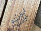 a close up of a piece of wood with writing on it