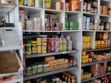 many shelves of food in a store with various items on them