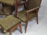 four chairs and a table in a room with a white background