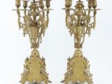 pair of antique brass candelabs on stands with ornate carvings