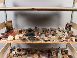 a shelf filled with rocks and rocks on top of a wooden table