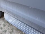a close up view of a car ' s bumper and tire