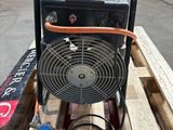 a fan sitting on top of a pallet in a warehouse