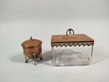two pieces of glass with a lid and a small metal object