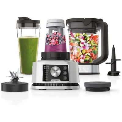 a blender with a green smoothie in it and a blender with a green smoothie in it